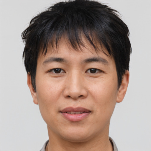 Joyful asian adult female with short  brown hair and brown eyes