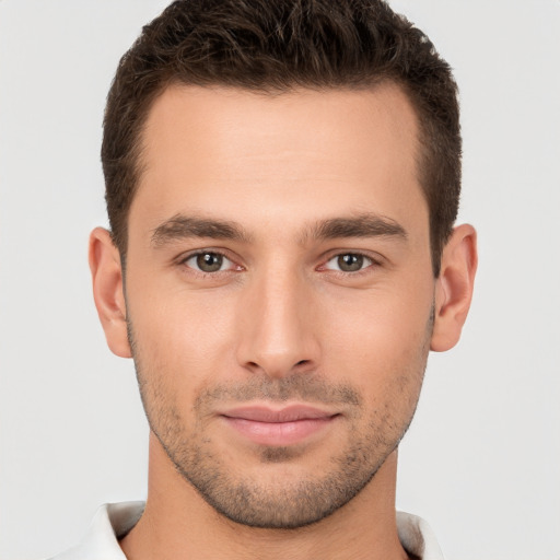 Joyful white young-adult male with short  brown hair and brown eyes