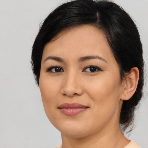 Joyful asian young-adult female with medium  brown hair and brown eyes