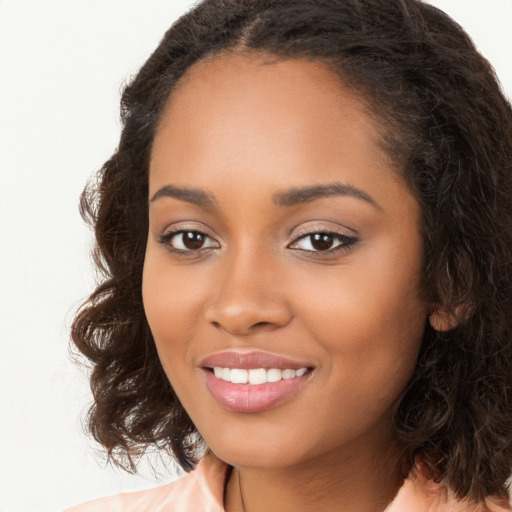 Joyful black young-adult female with long  brown hair and brown eyes