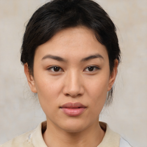 Joyful asian young-adult female with medium  brown hair and brown eyes