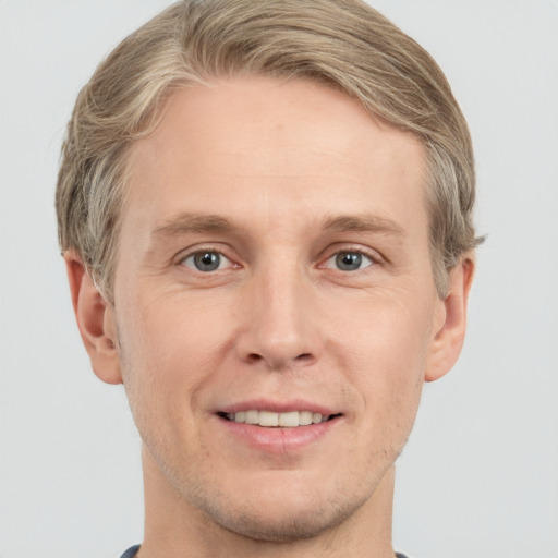 Joyful white adult male with short  brown hair and grey eyes