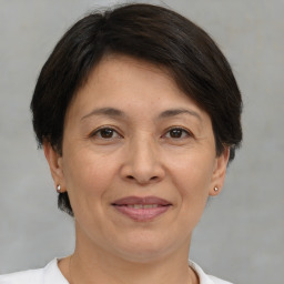 Joyful white adult female with short  brown hair and brown eyes