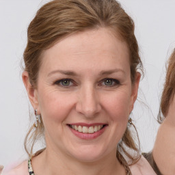 Joyful white young-adult female with medium  brown hair and blue eyes