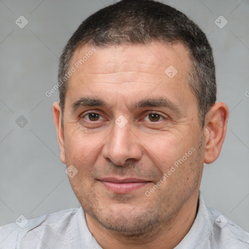 Joyful white adult male with short  brown hair and brown eyes