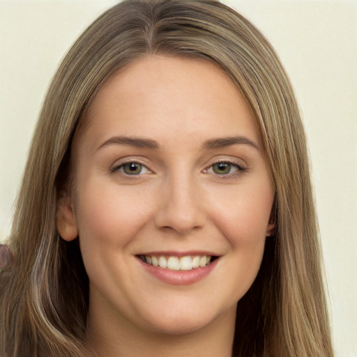 Joyful white young-adult female with long  brown hair and green eyes