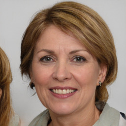 Joyful white adult female with medium  brown hair and blue eyes