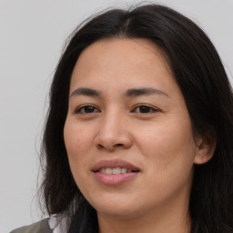 Joyful asian young-adult female with long  brown hair and brown eyes