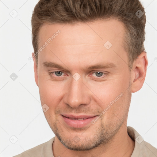 Joyful white adult male with short  brown hair and brown eyes