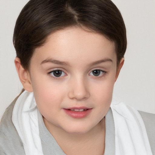 Joyful white child female with short  brown hair and brown eyes