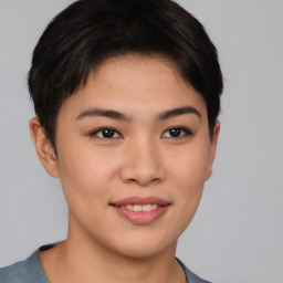 Joyful asian young-adult female with short  brown hair and brown eyes