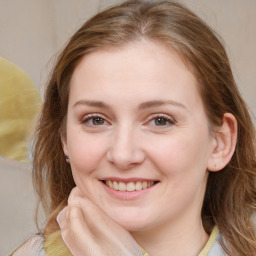 Joyful white young-adult female with medium  brown hair and blue eyes