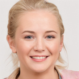 Joyful white young-adult female with long  brown hair and blue eyes