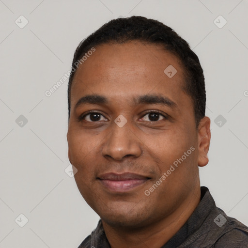 Joyful black young-adult male with short  black hair and brown eyes