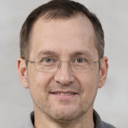 Joyful white adult male with short  brown hair and brown eyes