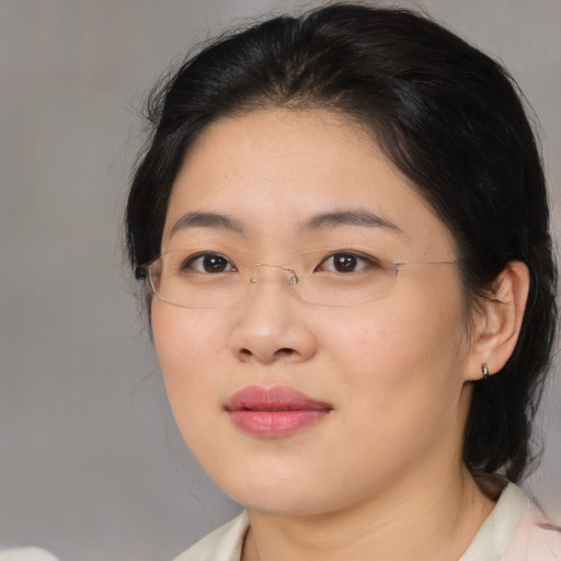 Joyful asian adult female with medium  brown hair and brown eyes