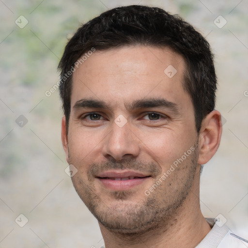 Joyful white young-adult male with short  black hair and brown eyes