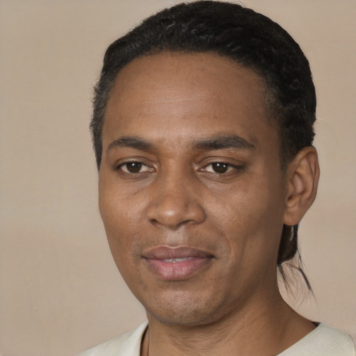 Joyful black adult male with short  black hair and brown eyes