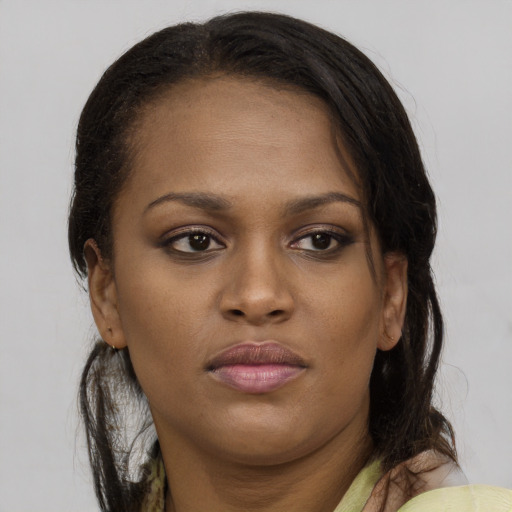 Neutral black young-adult female with long  brown hair and brown eyes