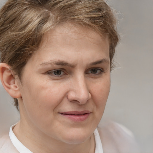 Joyful white adult female with medium  brown hair and brown eyes