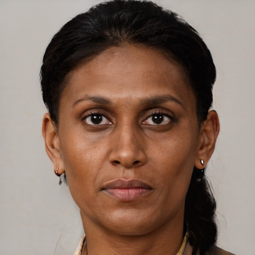 Neutral latino adult female with short  brown hair and brown eyes