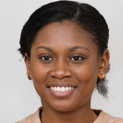 Joyful black young-adult female with medium  brown hair and brown eyes