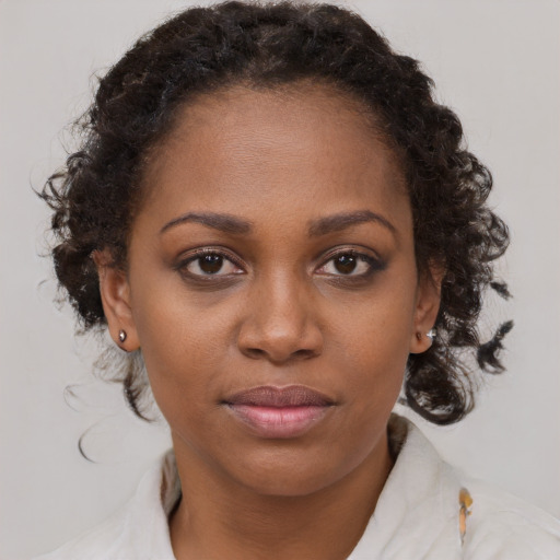 Joyful black young-adult female with medium  brown hair and brown eyes