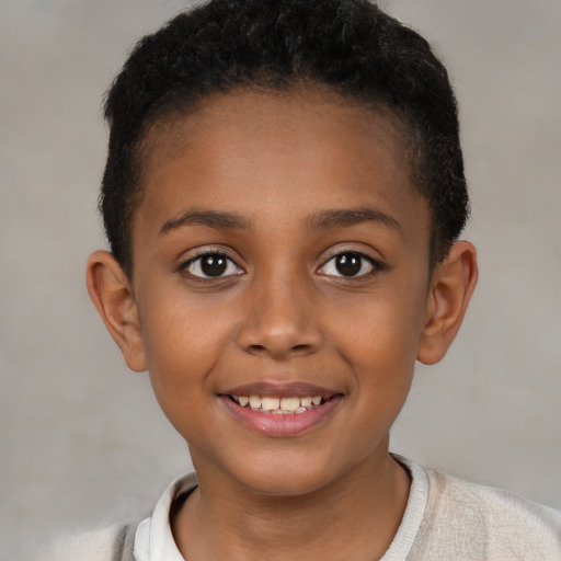 Joyful black child female with short  brown hair and brown eyes