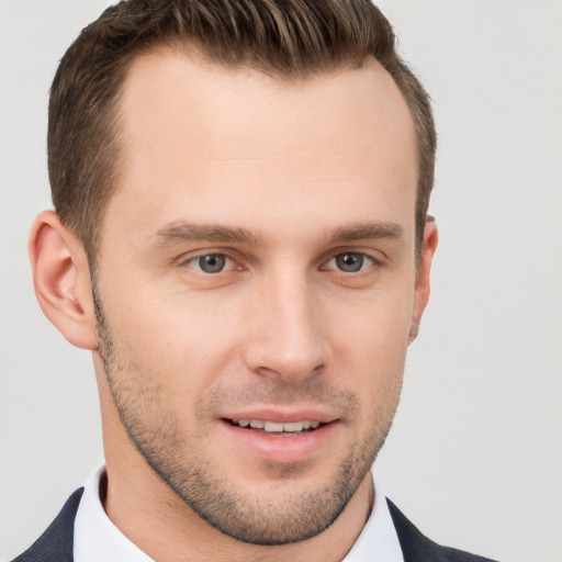 Joyful white young-adult male with short  brown hair and brown eyes