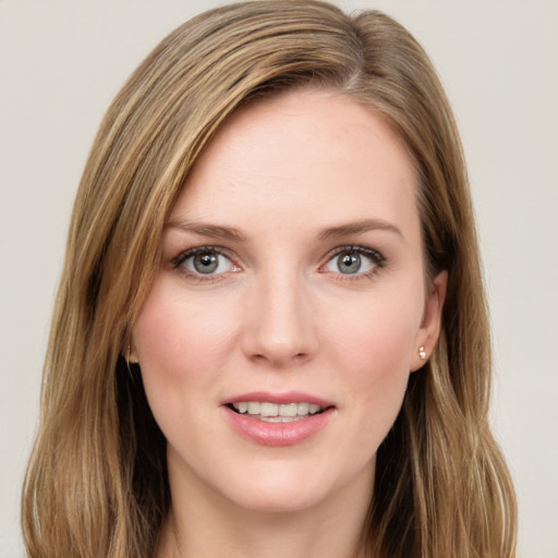 Joyful white young-adult female with long  brown hair and green eyes