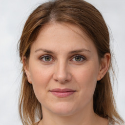 Joyful white young-adult female with medium  brown hair and grey eyes