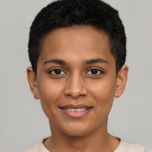 Joyful black young-adult female with short  brown hair and brown eyes
