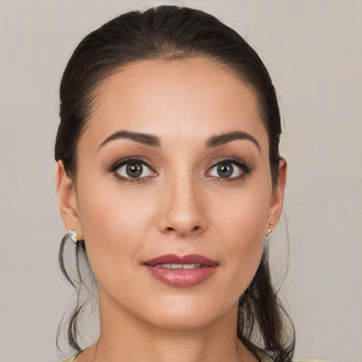 Joyful white young-adult female with medium  brown hair and brown eyes