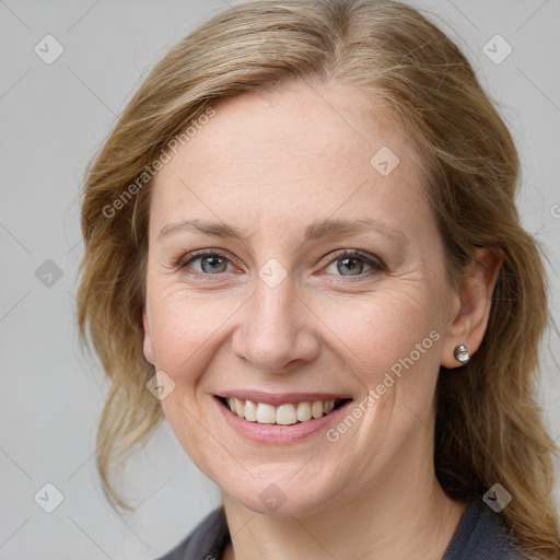 Joyful white young-adult female with medium  brown hair and blue eyes