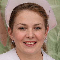 Joyful white adult female with medium  brown hair and brown eyes