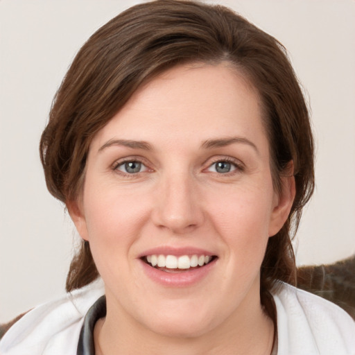 Joyful white young-adult female with medium  brown hair and grey eyes