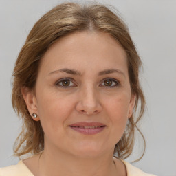 Joyful white adult female with medium  brown hair and brown eyes