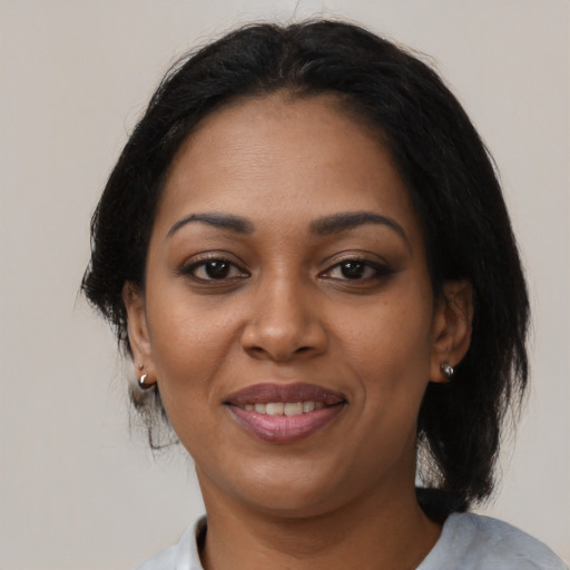 Joyful black young-adult female with medium  black hair and brown eyes