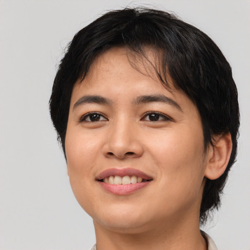 Joyful asian young-adult female with short  brown hair and brown eyes