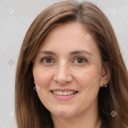 Joyful white adult female with long  brown hair and brown eyes