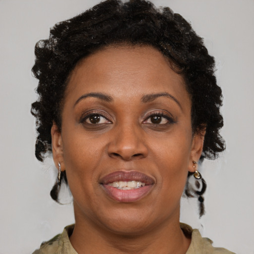 Joyful black adult female with short  brown hair and brown eyes