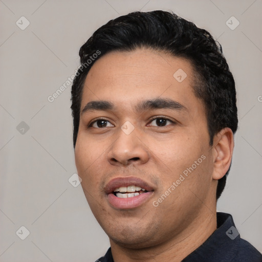 Joyful white young-adult male with short  black hair and brown eyes