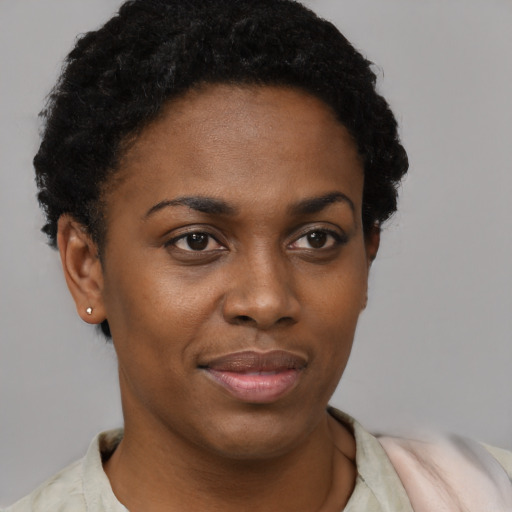 Joyful black young-adult female with short  brown hair and brown eyes