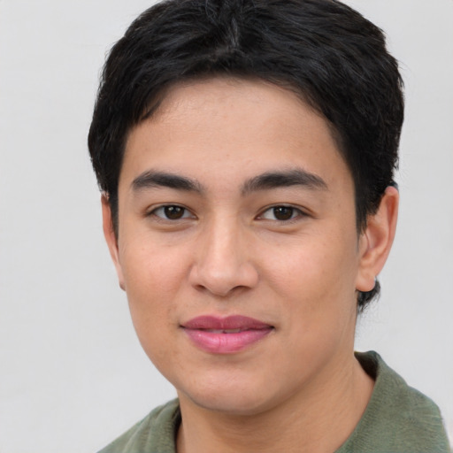 Joyful asian young-adult male with short  brown hair and brown eyes
