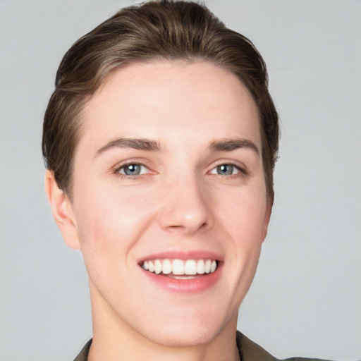 Joyful white young-adult female with short  brown hair and grey eyes