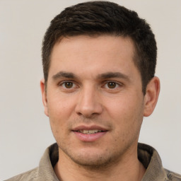 Joyful white young-adult male with short  brown hair and brown eyes