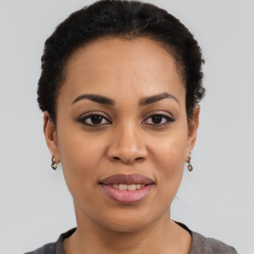 Joyful black young-adult female with short  brown hair and brown eyes