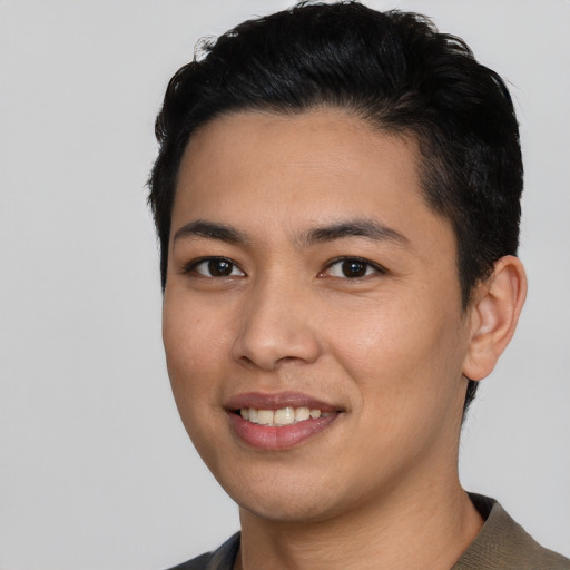 Joyful latino young-adult male with short  black hair and brown eyes