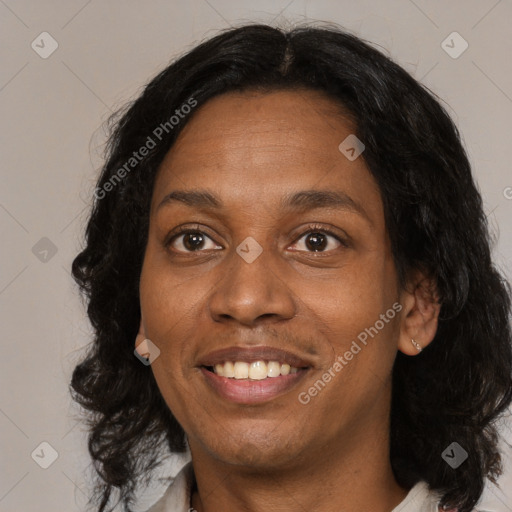 Joyful black adult female with medium  brown hair and brown eyes