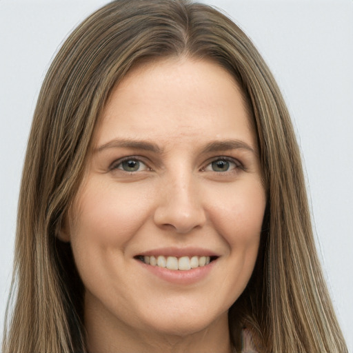 Joyful white young-adult female with long  brown hair and green eyes